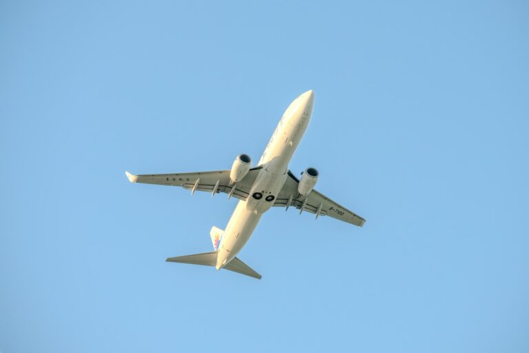 A large jetliner flying through a blue sky